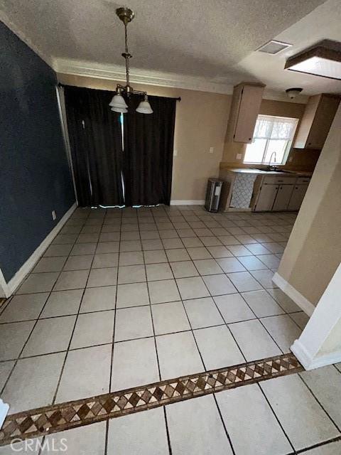 18145 10th St, Bloomington, CA 92316 - kitchen with light tile patterned flooring, a textured ceiling, pendant lighting, and a chandelier