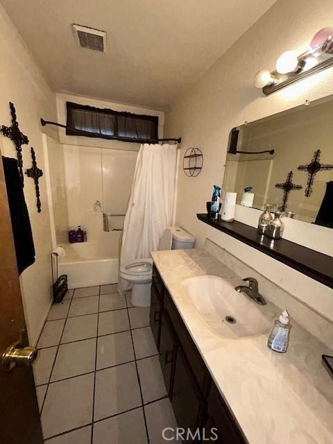 18145 10th St, Bloomington, CA 92316 - bathroom with vanity, tile patterned floors, and shower / tub combo