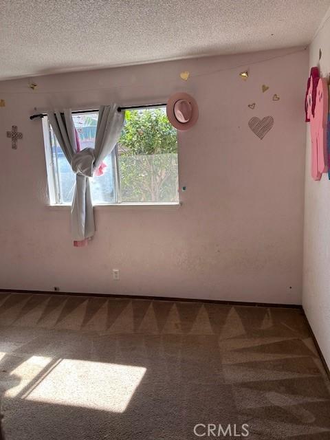 18145 10th St, Bloomington, CA 92316 - carpeted spare room featuring a textured ceiling