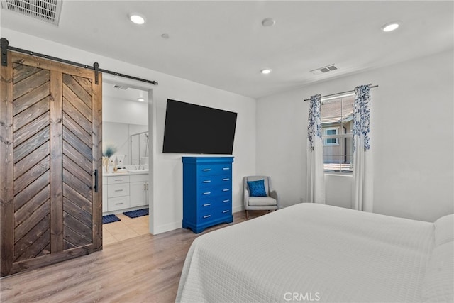 12062 Turnleaf Ave, Whittier, CA 90602 - bedroom featuring wood finished floors, a barn door, recessed lighting, and connected bathroom