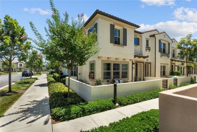 12062 Turnleaf Ave, Whittier, CA 90602 - back of house with stucco siding, a fenced front yard, a tile roof, and a residential view