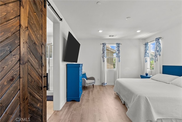12062 Turnleaf Ave, Whittier, CA 90602 - bedroom with a barn door, light wood finished floors, and recessed lighting