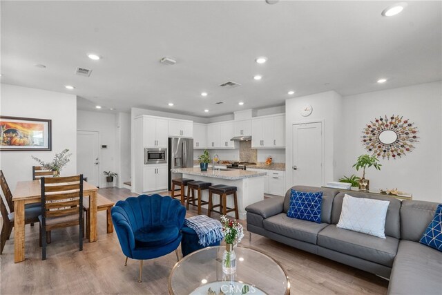12062 Turnleaf Ave, Whittier, CA 90602 - living area featuring light wood-style flooring and recessed lighting