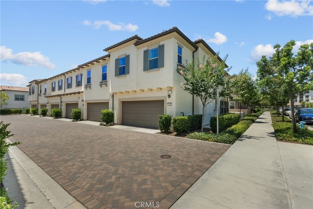 12062 Turnleaf Ave, Whittier, CA 90602 - view of front of home with driveway, a garage, stucco siding, and a residential view