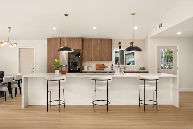 835 Cathy Ln, Cardiff By The Sea, CA 92007 - kitchen featuring brown cabinetry, light wood-style flooring, modern cabinets, light countertops, and recessed lighting