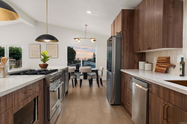 835 Cathy Ln, Cardiff By The Sea, CA 92007 - kitchen featuring stainless steel appliances, decorative backsplash, decorative light fixtures, a chandelier, and light wood-style floors