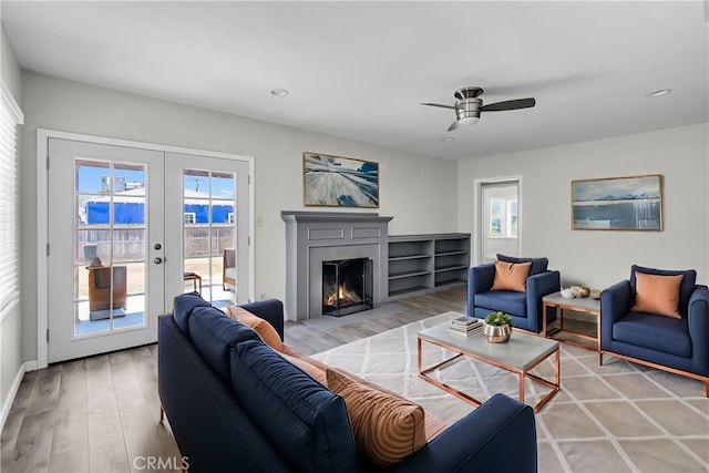 6017 Brockton Ave, Riverside, CA 92506 - living room with light wood-type flooring, a lit fireplace, a ceiling fan, recessed lighting, and french doors
