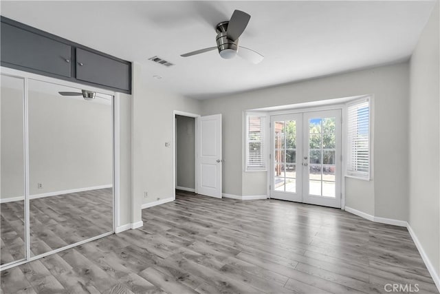 6017 Brockton Ave, Riverside, CA 92506 - unfurnished bedroom featuring access to outside, wood finished floors, french doors, a ceiling fan, and a closet