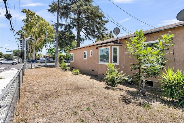 6017 Brockton Ave, Riverside, CA 92506 - view of side of home featuring crawl space and stucco siding