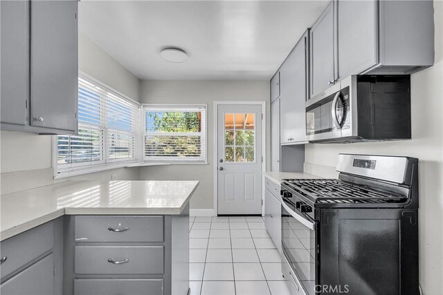 6017 Brockton Ave, Riverside, CA 92506 - kitchen featuring gray cabinets, appliances with stainless steel finishes, light countertops, and plenty of natural light