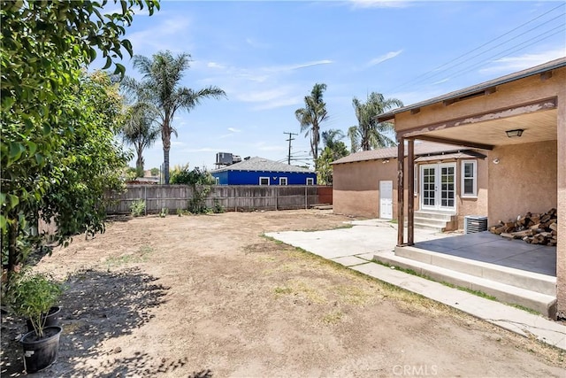 6017 Brockton Ave, Riverside, CA 92506 - fenced backyard featuring a patio, entry steps, and french doors