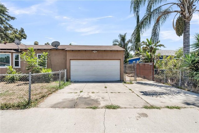 6017 Brockton Ave, Riverside, CA 92506 - view of front of house with concrete driveway, stucco siding, and an attached garage
