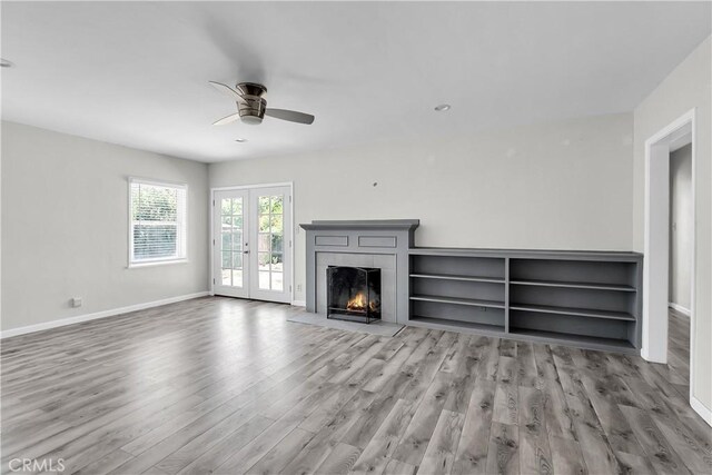 6017 Brockton Ave, Riverside, CA 92506 - unfurnished living room with a ceiling fan, wood finished floors, french doors, and a tile fireplace