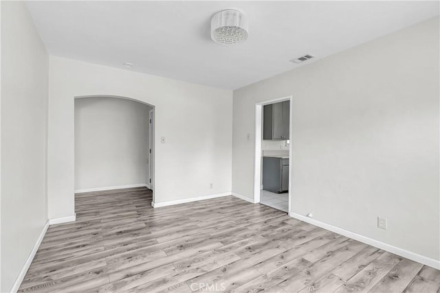 6017 Brockton Ave, Riverside, CA 92506 - unfurnished room with arched walkways and light wood finished floors