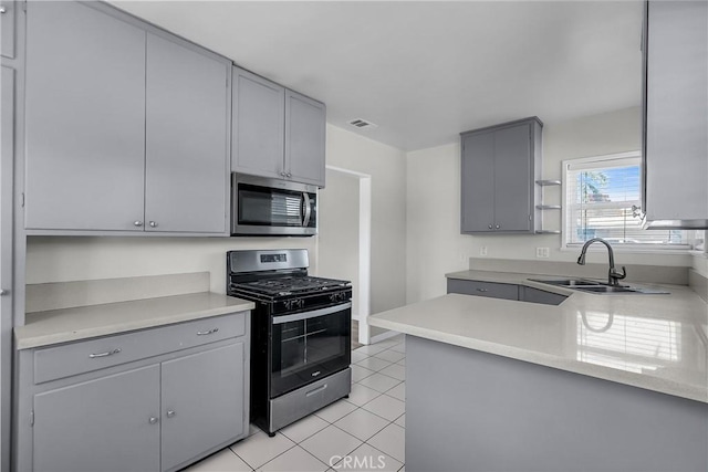 6017 Brockton Ave, Riverside, CA 92506 - kitchen with stainless steel appliances, gray cabinets, light tile patterned flooring, and light countertops