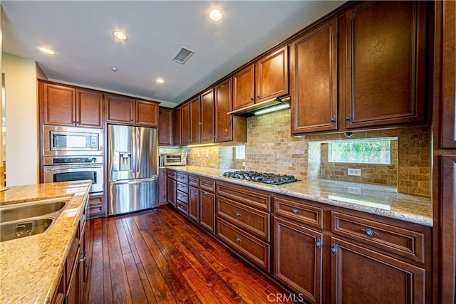 18956 Northern Dancer Ln, Yorba Linda, CA 92886 - kitchen with stainless steel appliances, dark wood-style flooring, light stone counters, tasteful backsplash, and recessed lighting