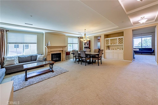 18956 Northern Dancer Ln, Yorba Linda, CA 92886 - dining space with a chandelier, light colored carpet, a fireplace, crown molding, and built in shelves