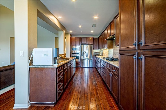 18956 Northern Dancer Ln, Yorba Linda, CA 92886 - kitchen with stainless steel appliances, dark wood-style flooring, under cabinet range hood, light stone countertops, and recessed lighting