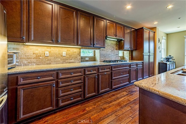 18956 Northern Dancer Ln, Yorba Linda, CA 92886 - kitchen featuring dark wood-type flooring, stainless steel gas stovetop, backsplash, recessed lighting, and light stone countertops