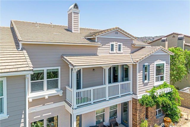 18956 Northern Dancer Ln, Yorba Linda, CA 92886 - back of property featuring a balcony, a chimney, and a tiled roof