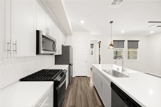 40497 Melrose Dr, Temecula, CA 92591 - kitchen featuring stainless steel appliances, dark wood-style floors, backsplash, white cabinetry, and recessed lighting