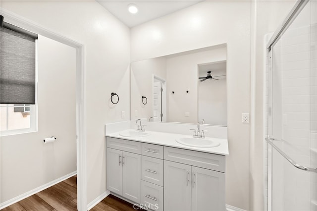 40497 Melrose Dr, Temecula, CA 92591 - full bathroom featuring double vanity, wood finished floors, a ceiling fan, and a shower with door