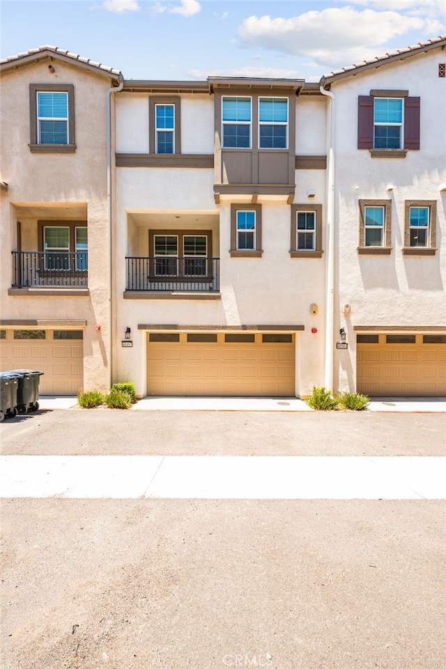 40497 Melrose Dr, Temecula, CA 92591 - view of front of house with an attached garage, stucco siding, and driveway