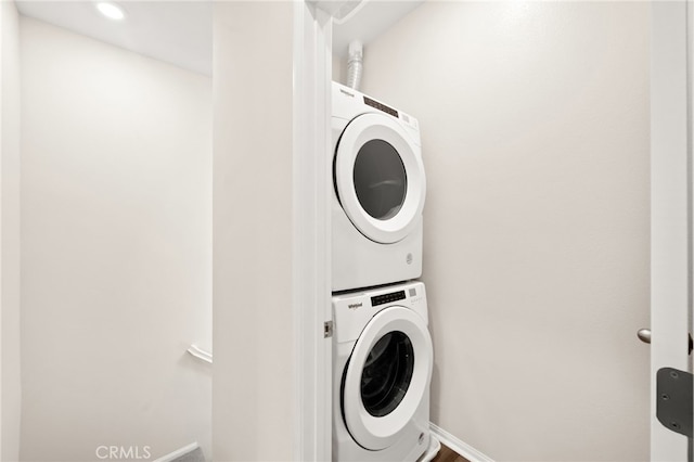40497 Melrose Dr, Temecula, CA 92591 - laundry area featuring stacked washer / dryer and baseboards