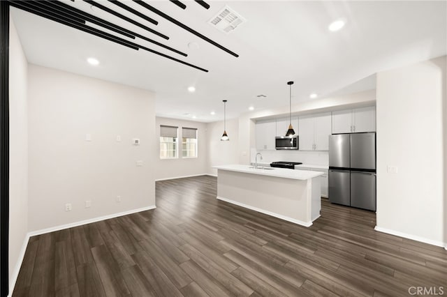 40497 Melrose Dr, Temecula, CA 92591 - kitchen with appliances with stainless steel finishes, recessed lighting, open floor plan, dark wood-type flooring, and white cabinetry
