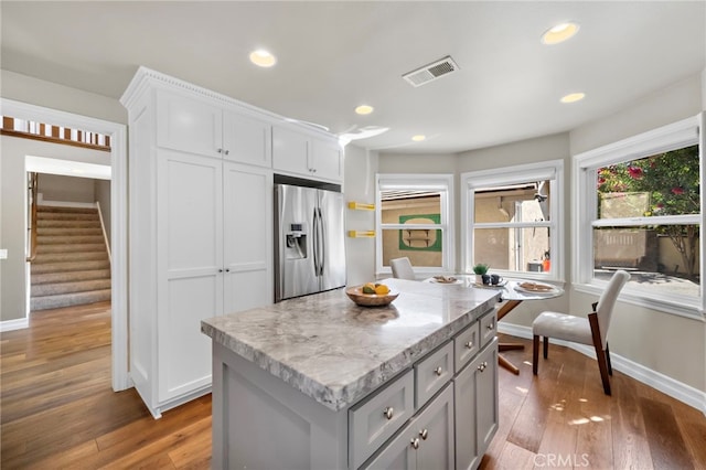 7543 E Twinleaf Trl, Orange, CA 92869 - kitchen with stainless steel fridge with ice dispenser, wood finished floors, a kitchen island, gray cabinets, and recessed lighting