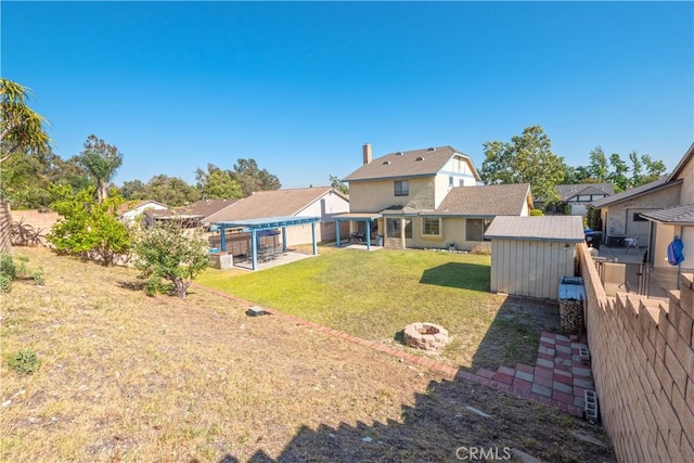 12356 Thistle Dr, Rancho Cucamonga, CA 91739 - rear view of property with a storage shed, a fenced backyard, a patio area, a pergola, and a fire pit