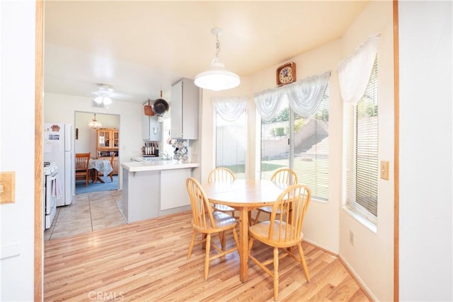 12356 Thistle Dr, Rancho Cucamonga, CA 91739 - dining area with light wood finished floors and a chandelier