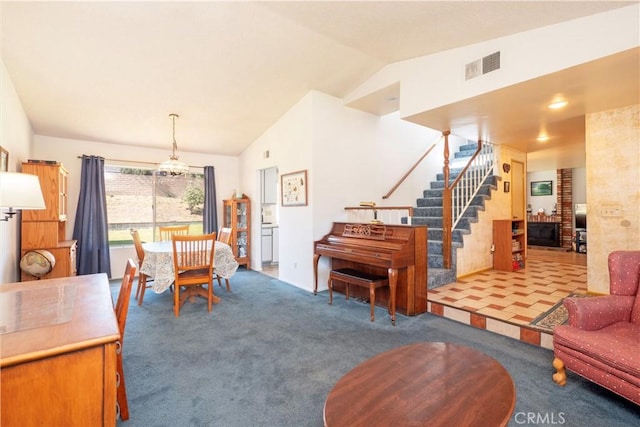 12356 Thistle Dr, Rancho Cucamonga, CA 91739 - carpeted living room featuring stairway, lofted ceiling, and a chandelier
