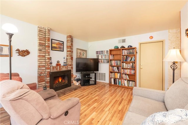 12356 Thistle Dr, Rancho Cucamonga, CA 91739 - living area featuring wood finished floors and a brick fireplace
