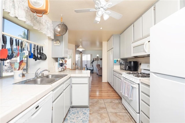 12356 Thistle Dr, Rancho Cucamonga, CA 91739 - kitchen featuring white appliances, tile counters, white cabinets, a ceiling fan, and light tile patterned flooring