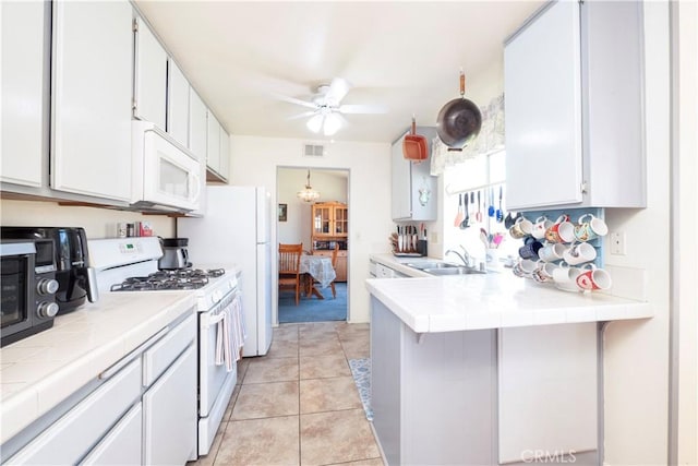 12356 Thistle Dr, Rancho Cucamonga, CA 91739 - kitchen featuring white appliances, tile countertops, a peninsula, and ceiling fan