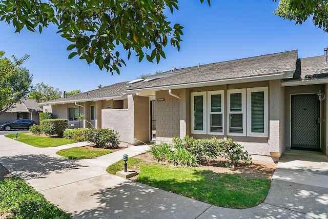 8815 Yuba Cir Unit 1102B, Huntington Beach, CA 92646 - view of front of home with stucco siding and a shingled roof