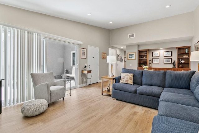 8815 Yuba Cir Unit 1102B, Huntington Beach, CA 92646 - living area featuring light wood-style floors, recessed lighting, built in shelves, and bar