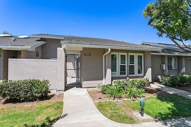 8815 Yuba Cir Unit 1102B, Huntington Beach, CA 92646 - view of front of home with roof with shingles and stucco siding