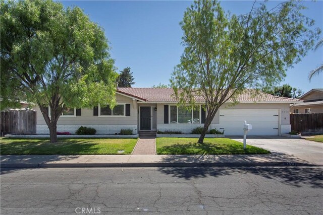 3360 Vanderbilt Ave, Turlock, CA 95382 - ranch-style house with an attached garage, concrete driveway, and a tiled roof