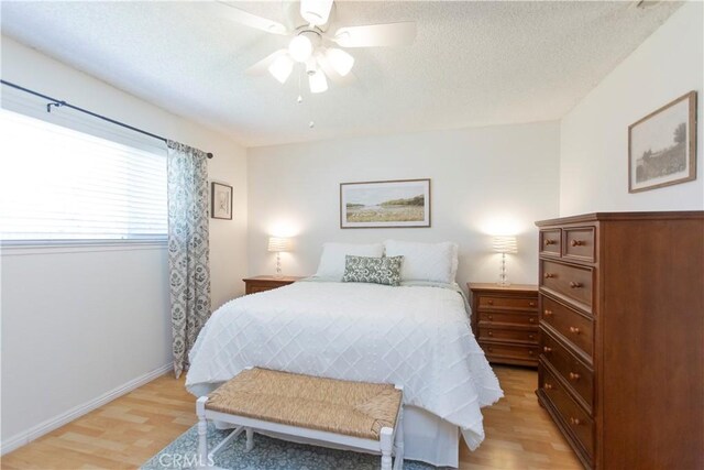 3360 Vanderbilt Ave, Turlock, CA 95382 - bedroom with light wood-style flooring, a textured ceiling, and a ceiling fan