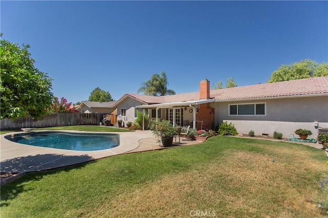 3360 Vanderbilt Ave, Turlock, CA 95382 - back of property with a chimney, a fenced backyard, stucco siding, a patio, and a tile roof