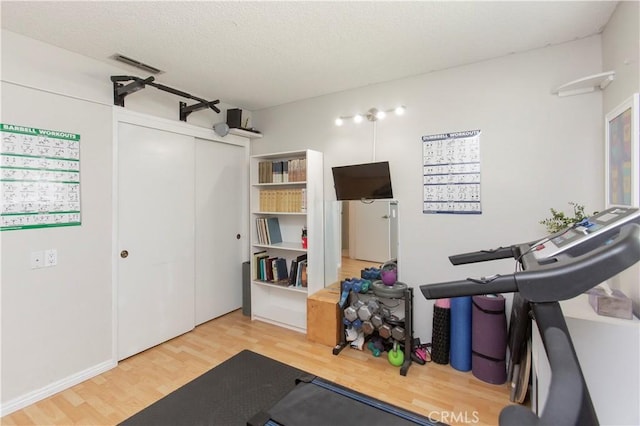 3360 Vanderbilt Ave, Turlock, CA 95382 - workout room featuring wood finished floors and a textured ceiling