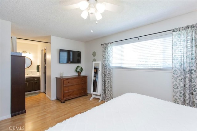 3360 Vanderbilt Ave, Turlock, CA 95382 - bedroom with light wood-style floors, a textured ceiling, ceiling fan, and connected bathroom