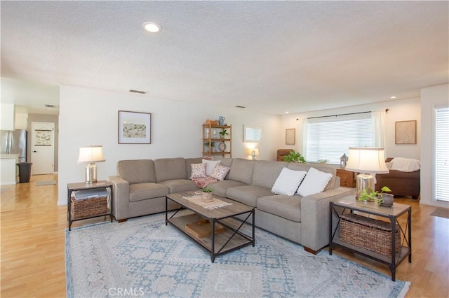 3360 Vanderbilt Ave, Turlock, CA 95382 - living area with light wood-style flooring, a textured ceiling, and recessed lighting
