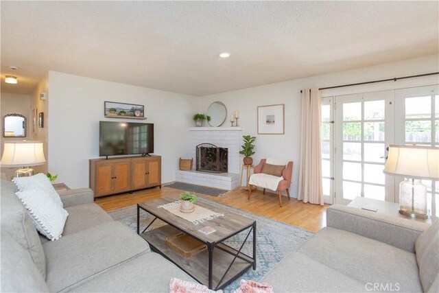 3360 Vanderbilt Ave, Turlock, CA 95382 - living area featuring wood finished floors, a brick fireplace, and recessed lighting