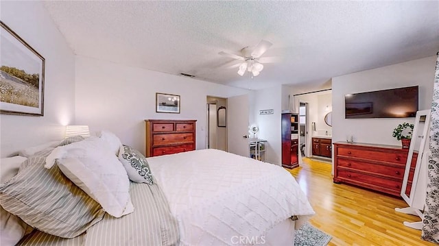 3360 Vanderbilt Ave, Turlock, CA 95382 - bedroom with light wood-style flooring, a textured ceiling, ensuite bathroom, and ceiling fan
