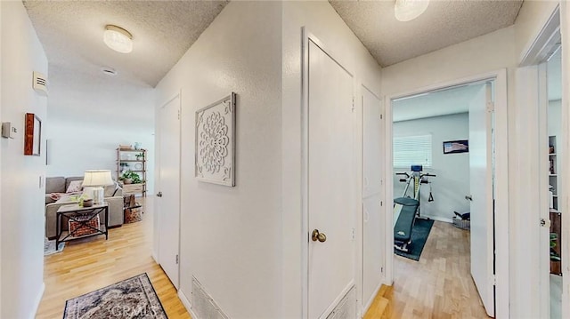 3360 Vanderbilt Ave, Turlock, CA 95382 - hallway with a textured ceiling and light wood-type flooring