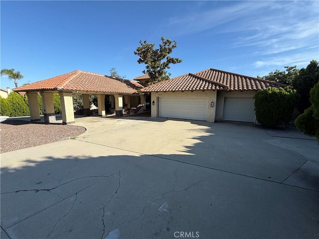 10919 Boulder Canyon Rd, Rancho Cucamonga, CA 91737 - mediterranean / spanish-style home featuring a garage, concrete driveway, stucco siding, and a tile roof