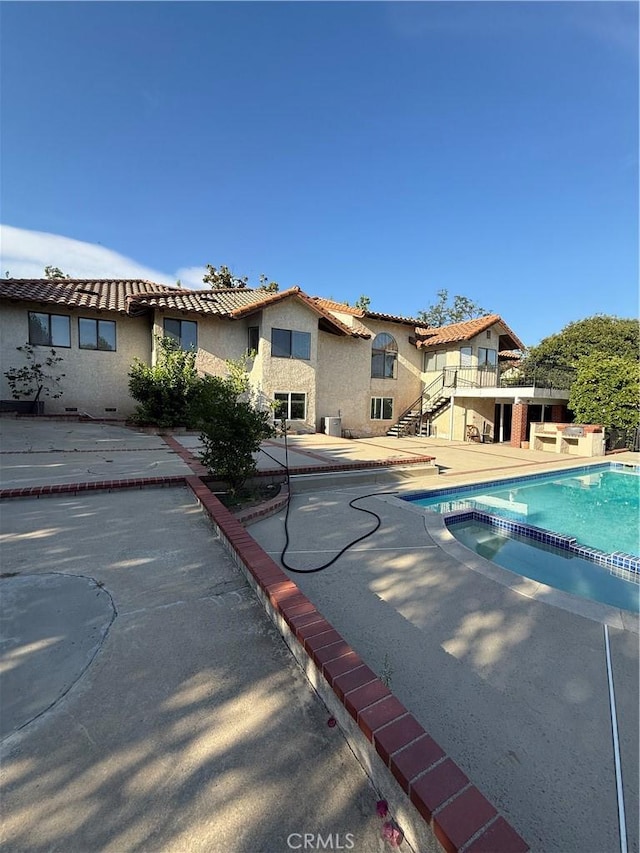 10919 Boulder Canyon Rd, Rancho Cucamonga, CA 91737 - view of swimming pool with a pool with connected hot tub, a patio area, and stairs